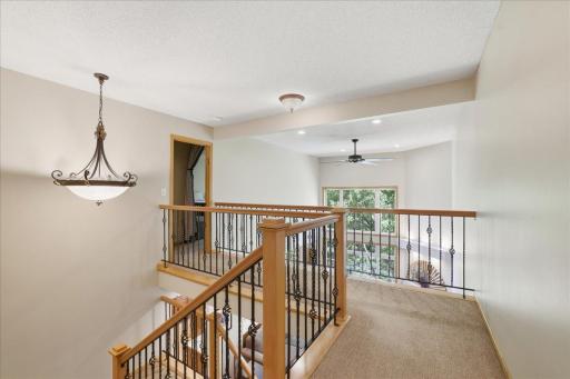 Stunning wrought iron railings, catwalk leading to your private, primary suite, retreat.