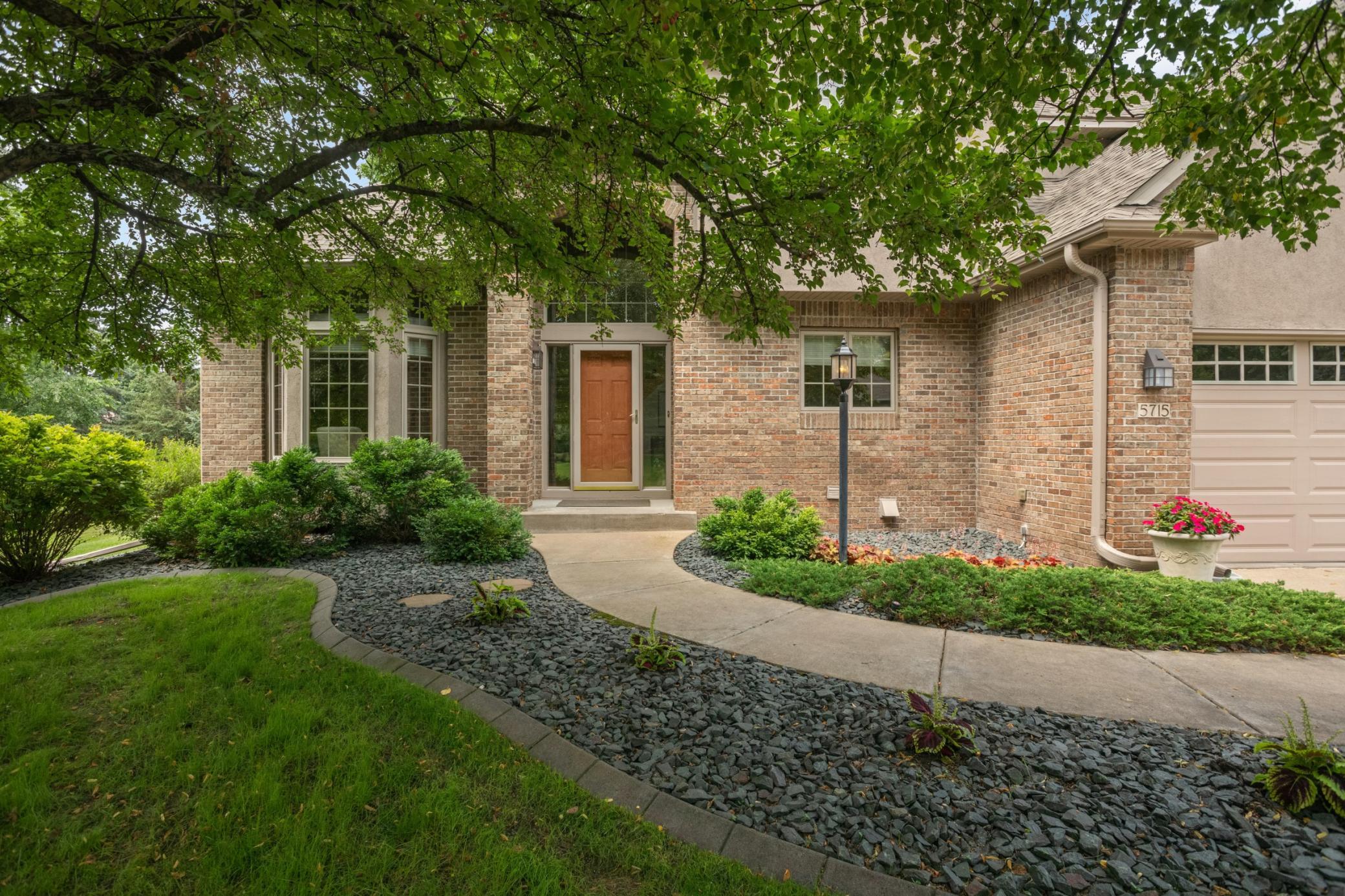 Great curb appeal, nice setting with green space, gardens and mature trees