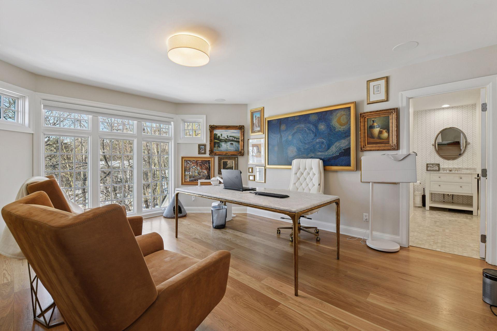 The upper level offers four bedrooms, three bathrooms, and a loft with built-in desks and shelving.