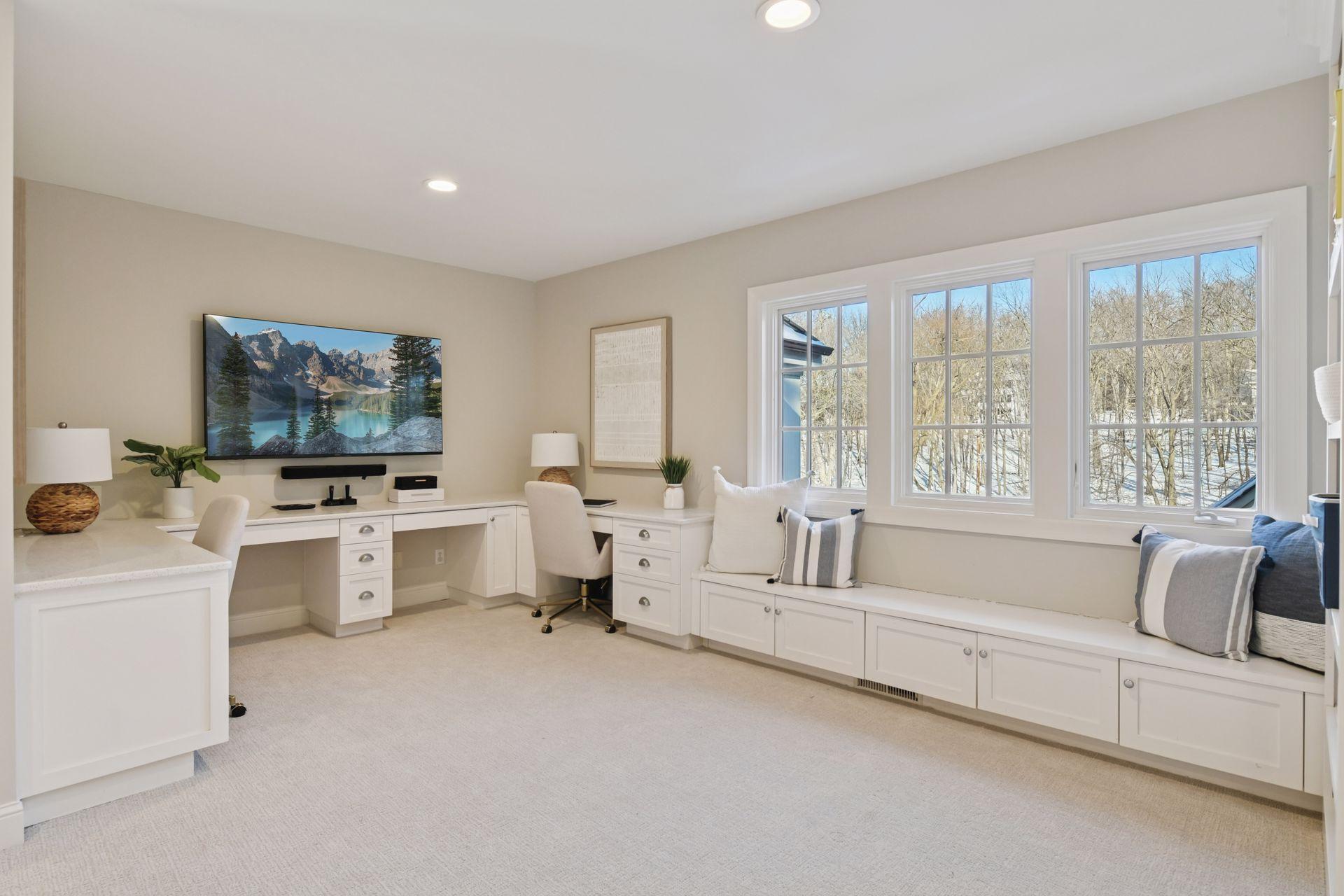 The upper level offers four bedrooms, three bathrooms, and a loft with built-in desks and shelving.