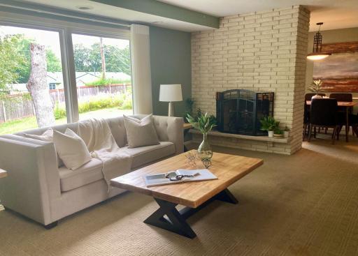Two sided fireplace between the living room and dining room