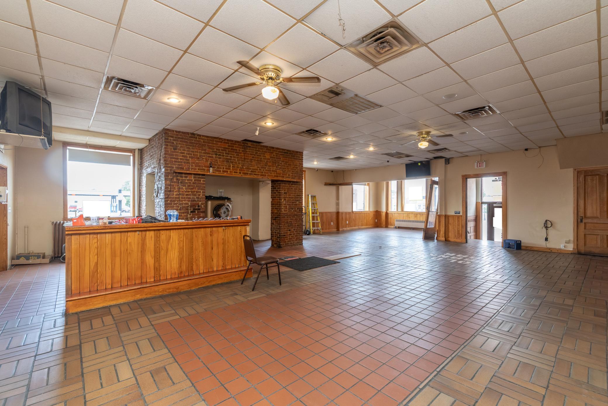 Main floor view of the former dining area, game room and bar