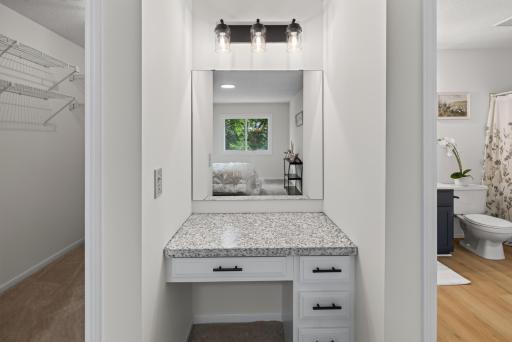 Main level: primary bedroom 1 with walk through bathroom, walk-in closet, and powder area
