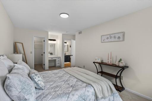 Main level: primary bedroom 1 with walk through bathroom, walk-in closet, and powder area