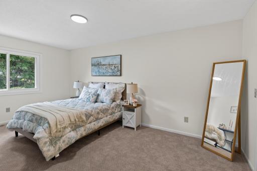 Main level: primary bedroom 1 with walk through bathroom, walk-in closet, and powder area
