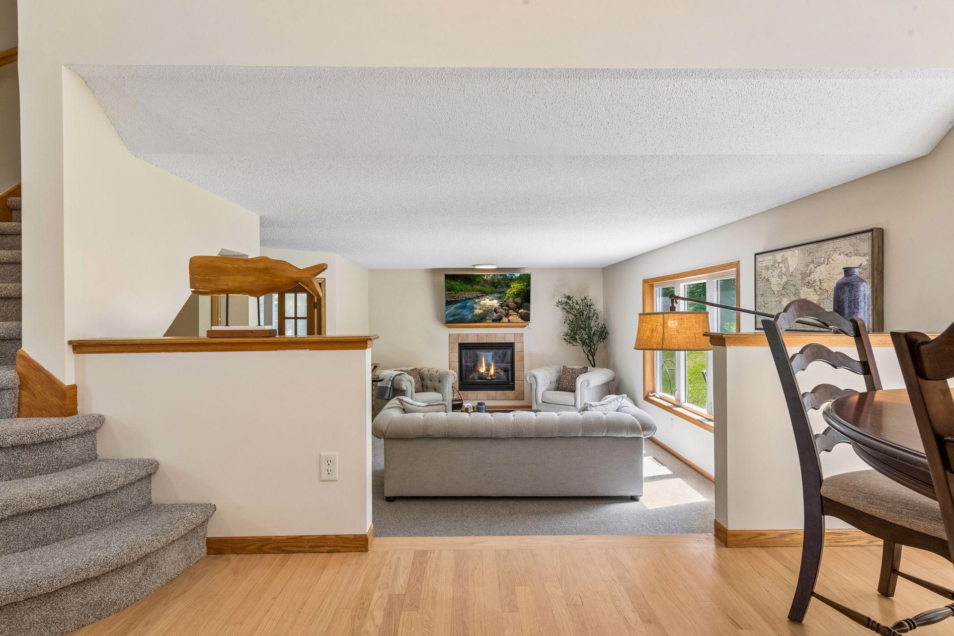 Architectural half walls create a graceful transition into the family room, offering an open feel while defining this warm and inviting living space.
