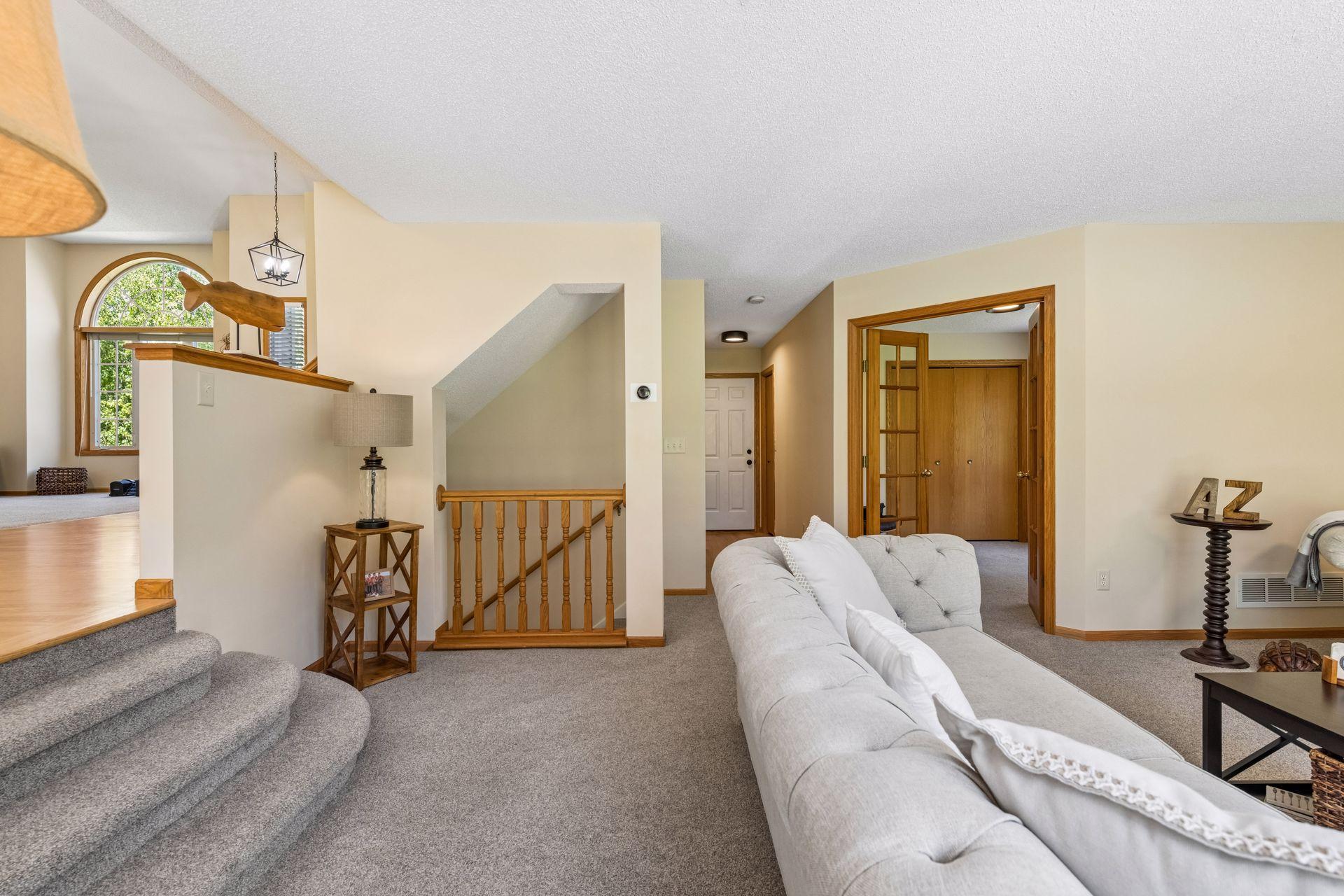 The open-railed stairwell leads to the unfinished lower level, offering abundant storage today and outstanding potential to expand your finished living space.