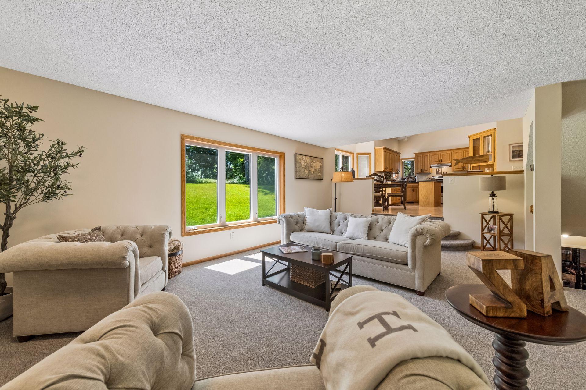 Looking back toward the main floor living spaces, three gentle steps create a seamless transition from the family room to the kitchen and dining area, maintaining an open flow while defining each space.