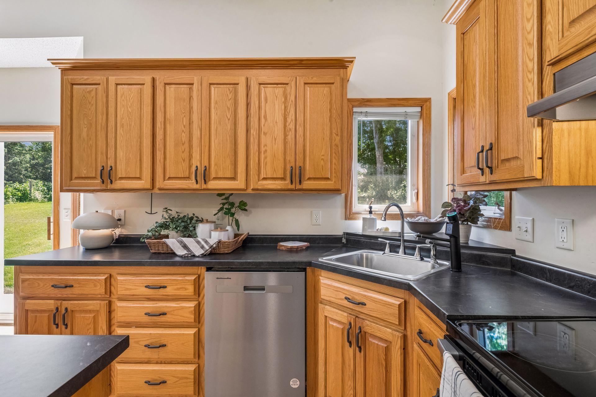 The corner sink is perfectly positioned beneath windows overlooking the backyard, bringing natural light into the kitchen while providing peaceful views as you prepare meals. Please note that the water filtration system will be removed prior to close