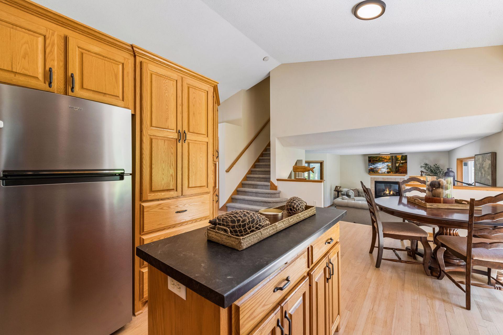 The center island features a convenient electrical outlet, while abundant cabinetry and drawers provide exceptional storage, keeping everything within easy reach for meal prep and daily use.
