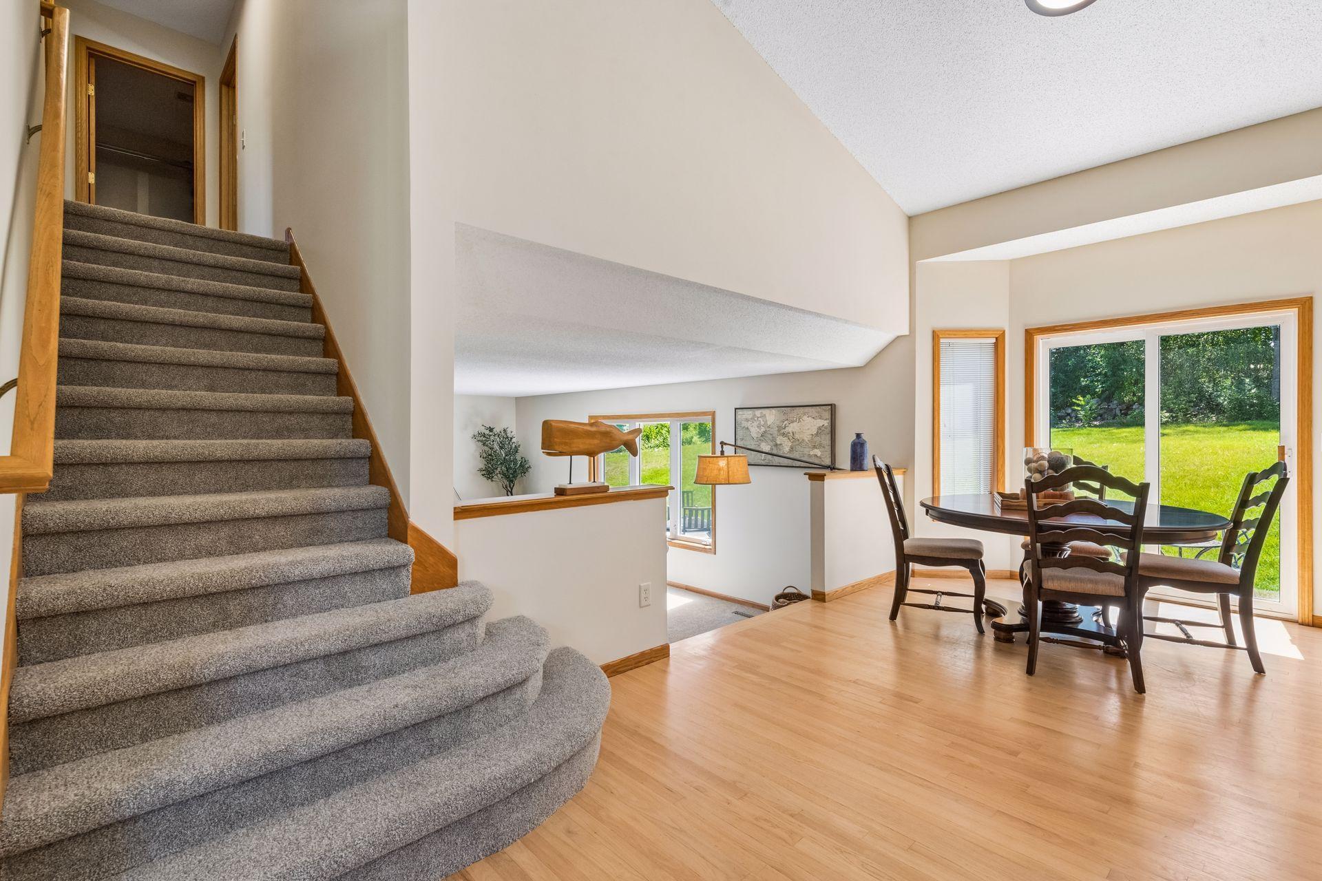 Gracefully connecting both levels, the staircase leads to three upper-level bedrooms, highlighted by a spacious primary suite with a private full bath.