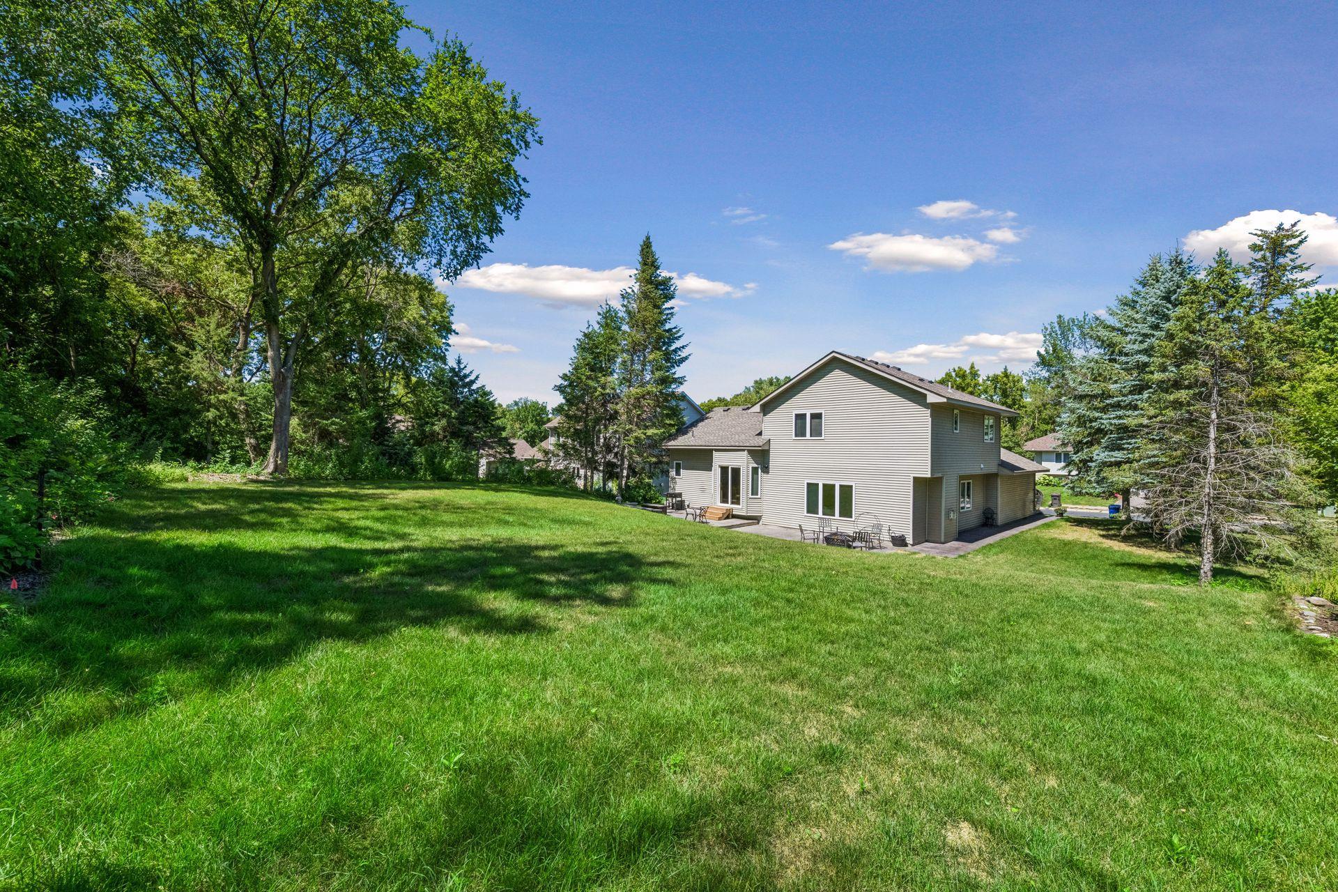 Enjoy a spacious backyard surrounded by mature trees. The sellers cleared brush and removed select trees to create an open, lush lawn with room to play, garden, entertain, or simply relax.