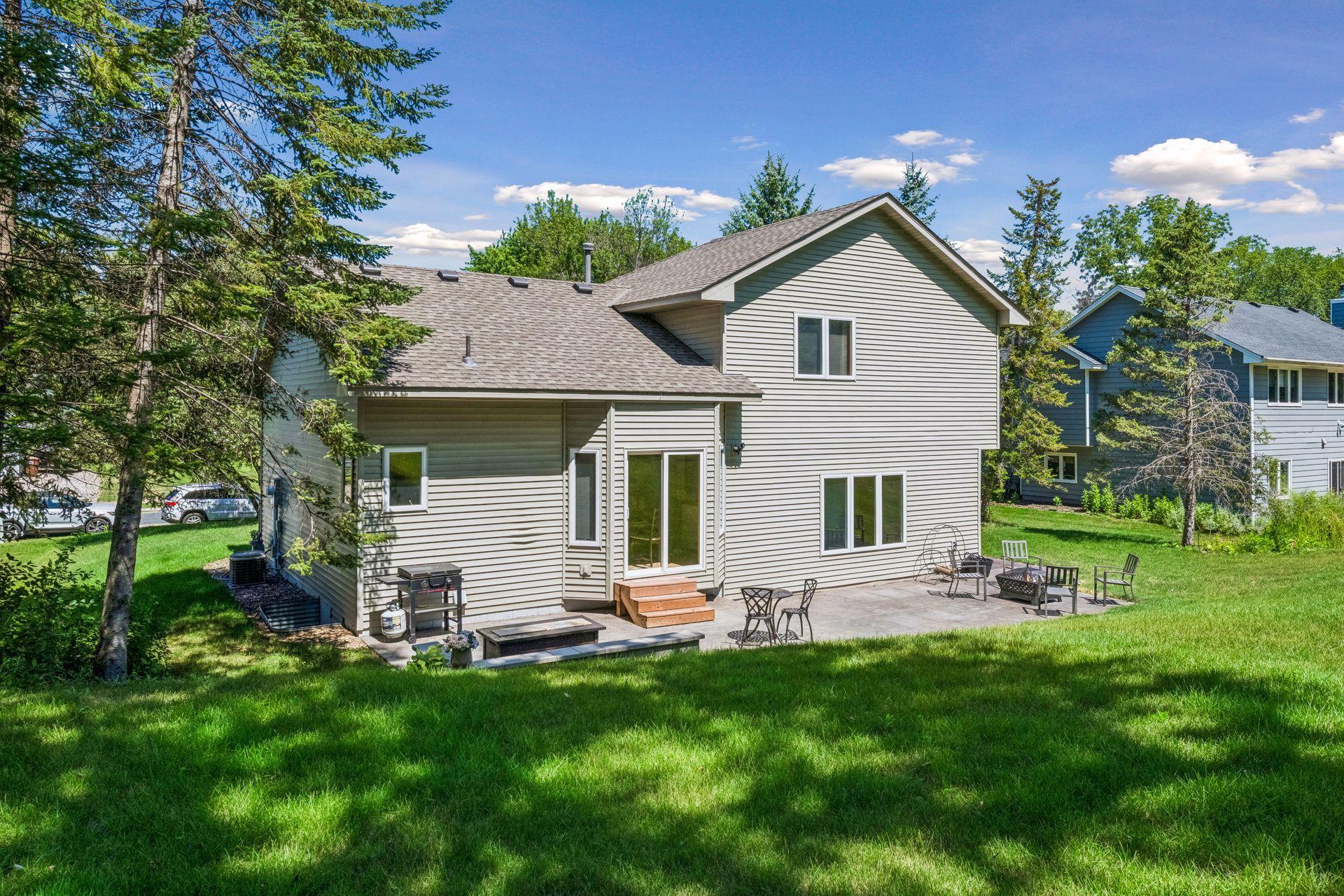 An expansive stamped concrete patio spans the length of the home and wraps around to the attached garage, creating exceptional space for outdoor dining, entertaining, and relaxing.