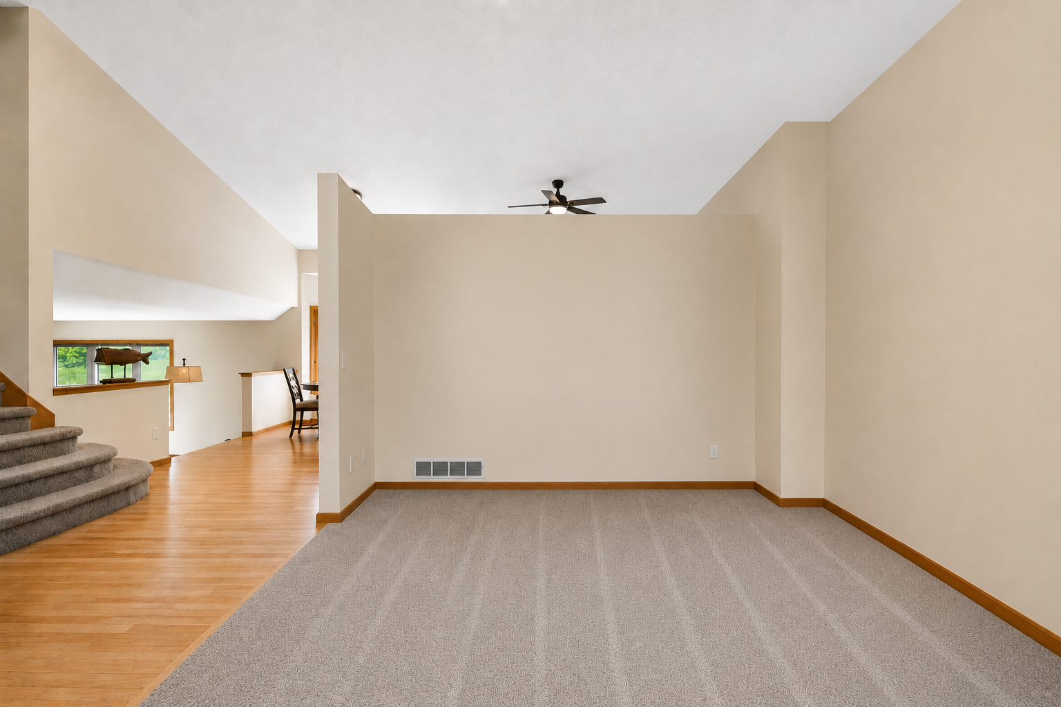 Digitally cleared to showcase the possibilities, this spacious living room offers a blank canvas ready for your personal style, furnishings, and design vision.