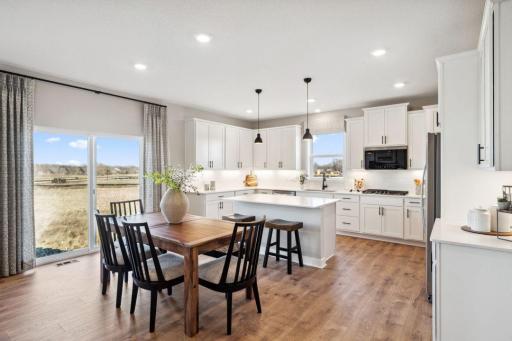 Open floor plan with huge walk in pantry, plus informal and formal dining area. Photo of a model home, color & options will vary.
