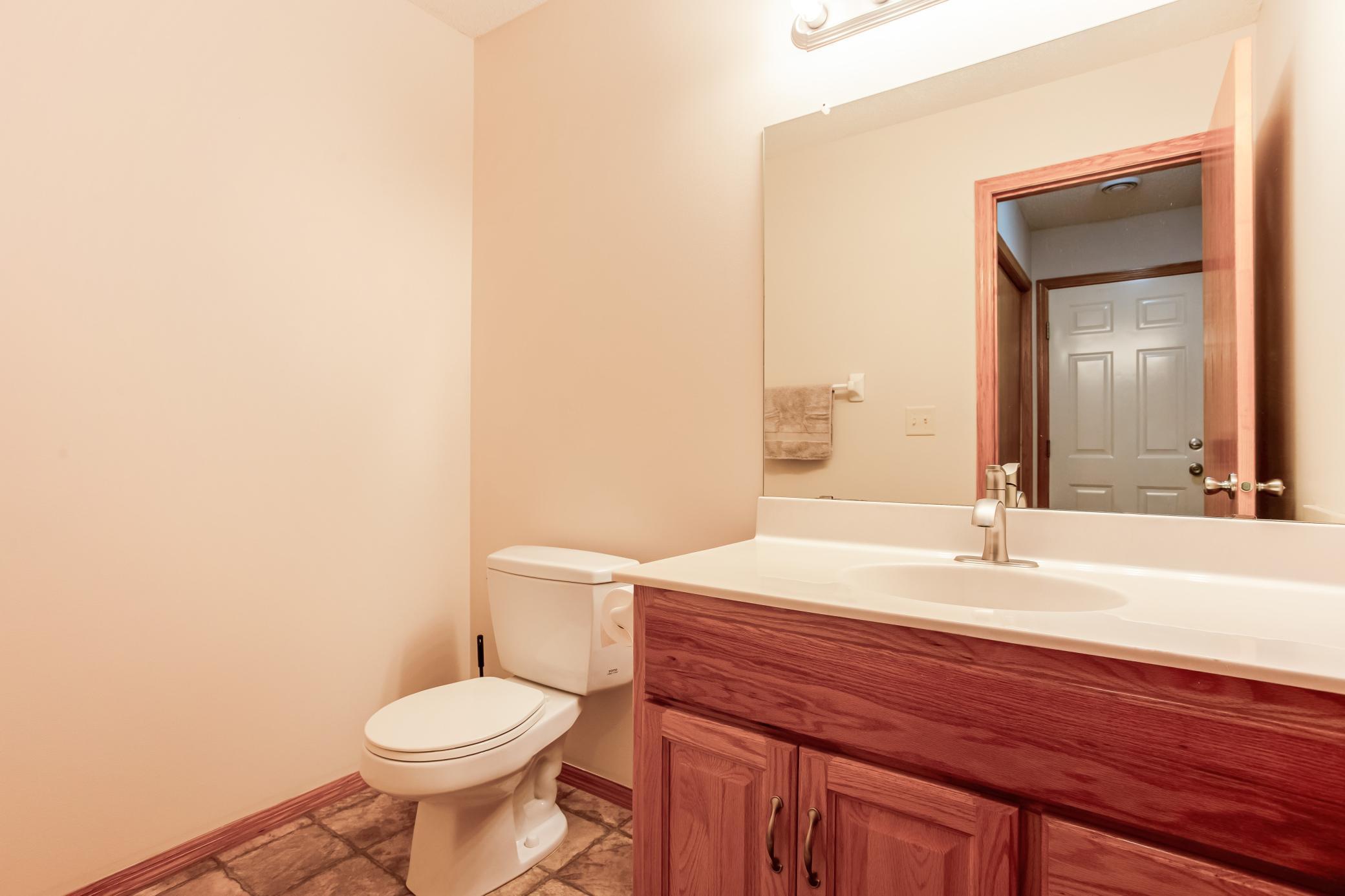 Convenient main-level half bath with ample vanity storage and a clean, neutral finish.