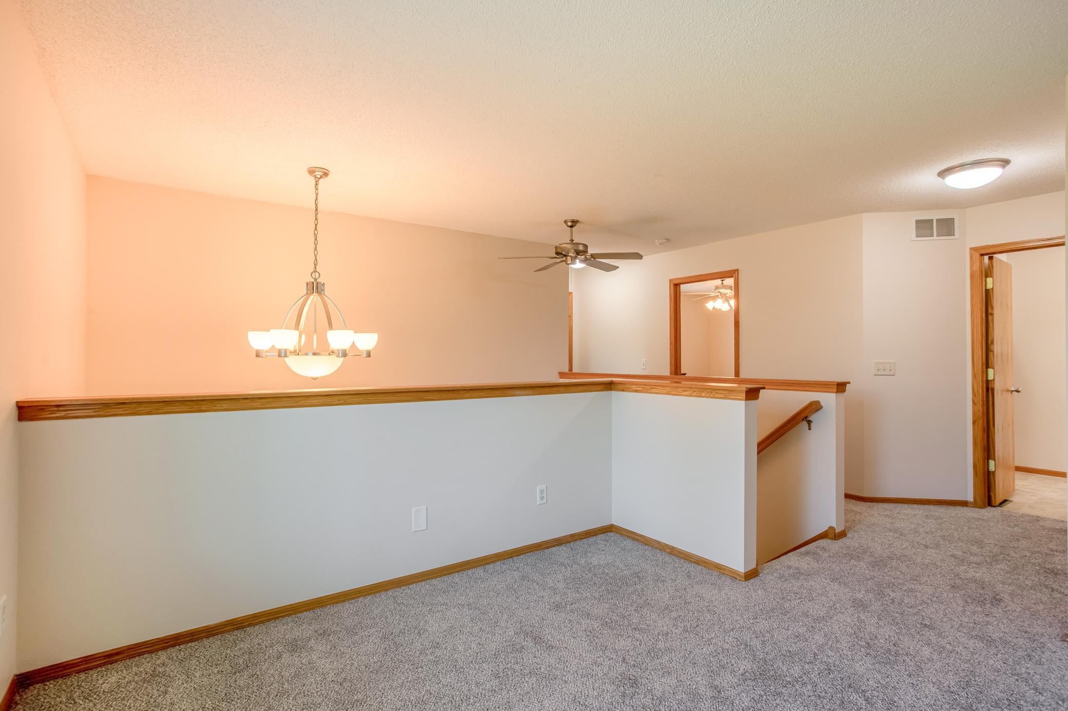 Cozy upstairs loft with brand-new carpet offers flexible space for a home office, reading nook, or additional living area.