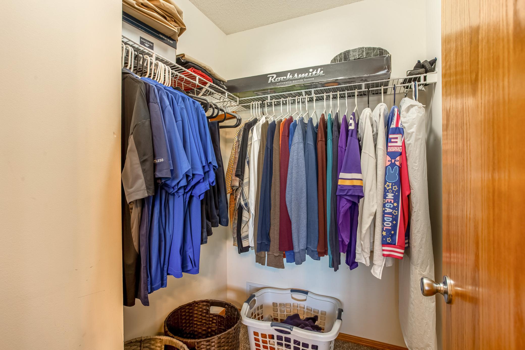 One of two walk-in closets in the primary suite offers generous hanging and storage space.