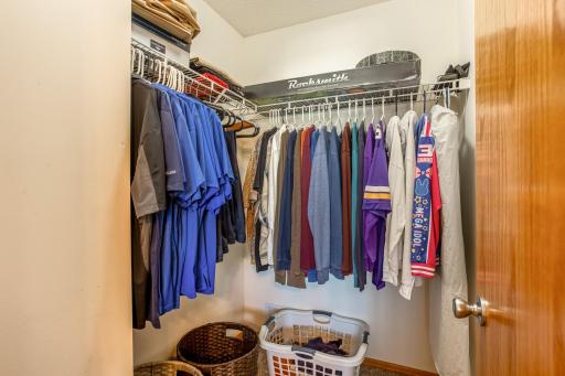 One of two walk-in closets in the primary suite offers generous hanging and storage space.