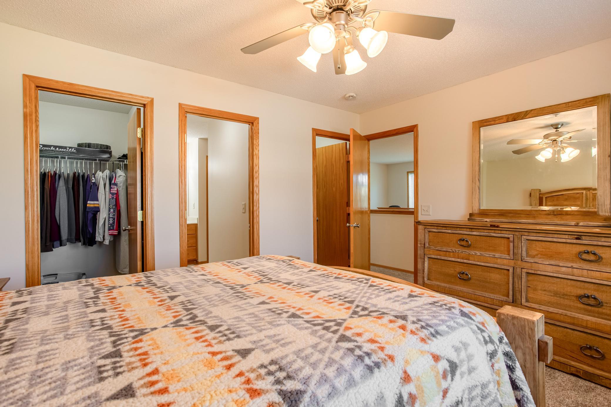 Thoughtful primary bedroom layout provides easy access to the walk-through bath and two separate walk-in closets.