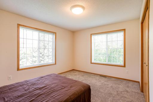 Bright secondary bedroom features brand-new carpet and two large windows for plentiful natural light.