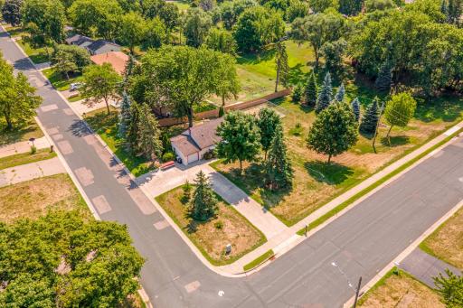 Aerial view showcases the home's desirable corner location and park-like setting, offering an impressive amount of outdoor space.