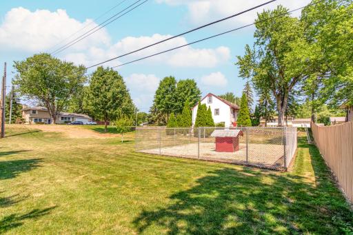 Expansive yard space showcases the park-like setting, with mature trees and plenty of open lawn to enjoy.