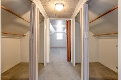 Upper-level hallway provides access to substantial closet and storage areas, maximizing the home's usable space.