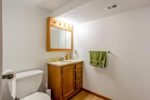 Lower-level bathroom features a separate shower and a practical layout for added household convenience.