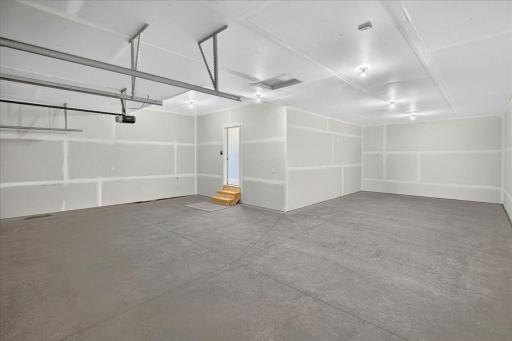 PHOTO OF A DIFFERENT HOME WITH SIMILAR PLAN & FINISHES. Spacious 4 BAY GARAGE (934 sq.ft.) offering an abundance of work space and storage! 3 stalls across the front of home and 4th bay tandem.