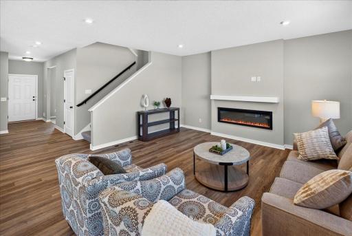 PHOTO OF A DIFFERENT HOME WITH SIMILAR PLAN & FINISHES. Great Room features a fireplace with mantle.