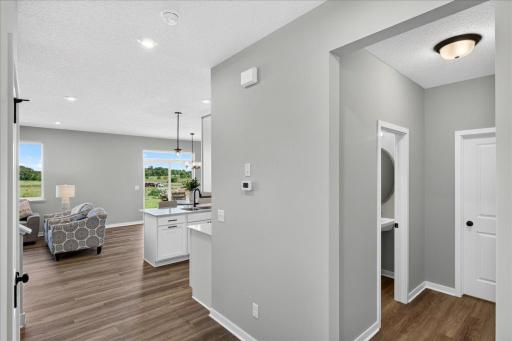PHOTO OF A DIFFERENT HOME WITH SIMILAR PLAN & FINISHES. Hallway view to the Mudroom, Kitchen, and Great Room.