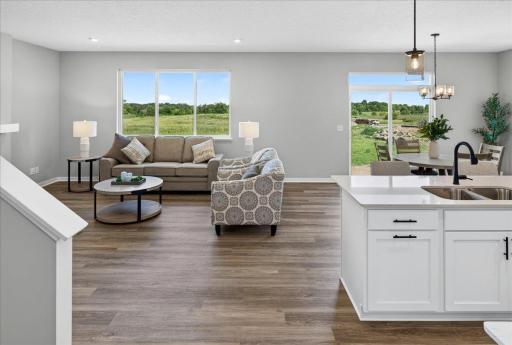 PHOTO OF A DIFFERENT HOME WITH SIMILAR PLAN & FINISHES. Dining and Great Room offer backyard views.