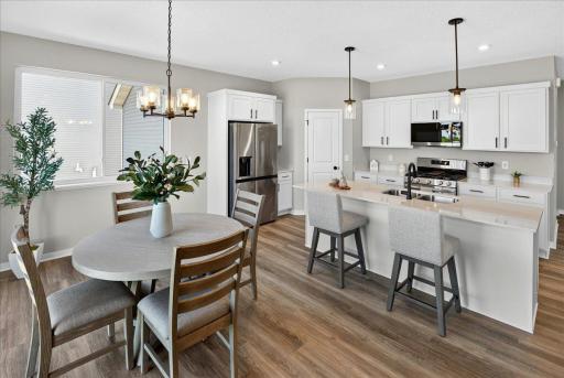 PHOTO OF A DIFFERENT HOME WITH SIMILAR PLAN & FINISHES. Kitchen features a spacious Center Island and Walk-in Pantry!