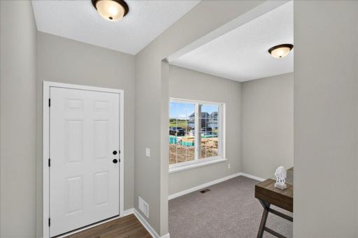 PHOTO OF A DIFFERENT HOME WITH SIMILAR PLAN & FINISHES. Foyer and Flex Room.