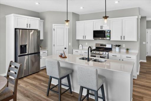 PHOTO OF A DIFFERENT HOME WITH SIMILAR PLAN & FINISHES. Kitchen features a spacious Center Island and Walk-in Pantry!