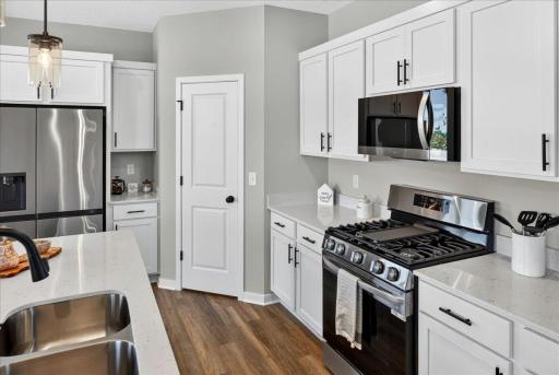 PHOTO OF A DIFFERENT HOME WITH SIMILAR PLAN & FINISHES.