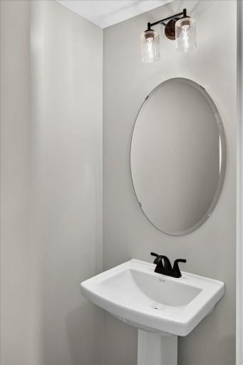 PHOTO OF A DIFFERENT HOME WITH SIMILAR PLAN & FINISHES. Half Bath.