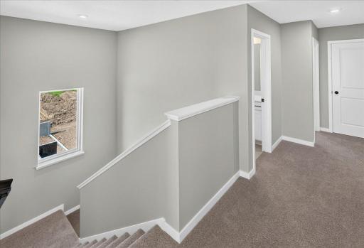 PHOTO OF A DIFFERENT HOME WITH SIMILAR PLAN & FINISHES. Upper floor hallway.
