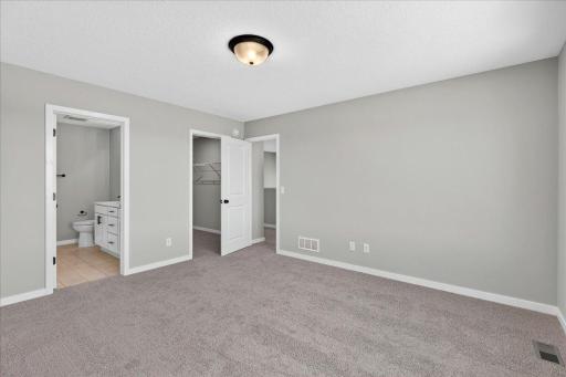 PHOTO OF A DIFFERENT HOME WITH SIMILAR PLAN & FINISHES. Primary Suite.