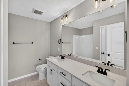 PHOTO OF A DIFFERENT HOME WITH SIMILAR PLAN & FINISHES. Primary Suite Private Bathroom.