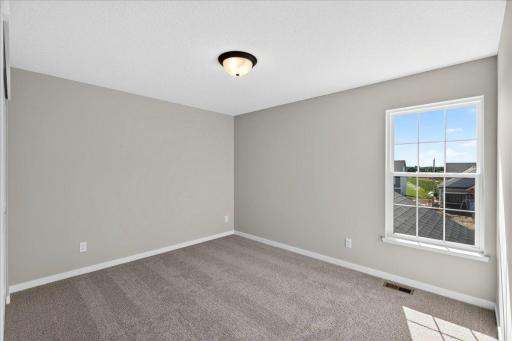PHOTO OF A DIFFERENT HOME WITH SIMILAR PLAN & FINISHES. Bedroom 2.