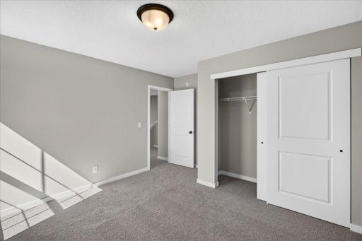 PHOTO OF A DIFFERENT HOME WITH SIMILAR PLAN & FINISHES. Bedroom 2.