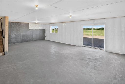 PHOTO OF A DIFFERENT HOME WITH SIMILAR PLAN & FINISHES. Unfinished Walkout Lower Level ready for future finish including a future family room, bedroom 5, and bathroom.