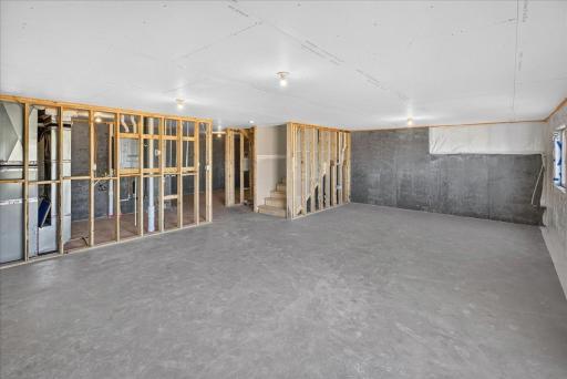 PHOTO OF A DIFFERENT HOME WITH SIMILAR PLAN & FINISHES. Unfinished Walkout Lower Level ready for future finish including a future family room, bedroom 5, and bathroom.