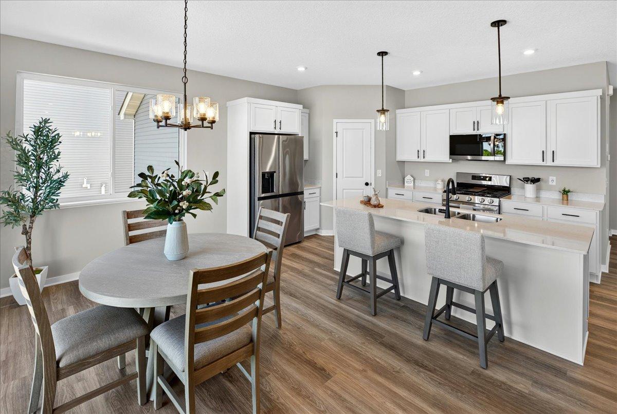 PHOTO OF A DIFFERENT HOME WITH SIMILAR PLAN & FINISHES. Kitchen features a spacious Center Island and Walk-in Pantry!