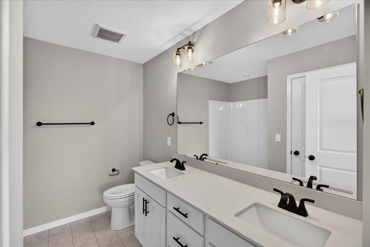 PHOTO OF A DIFFERENT HOME WITH SIMILAR PLAN & FINISHES. Primary Suite Private Bathroom.