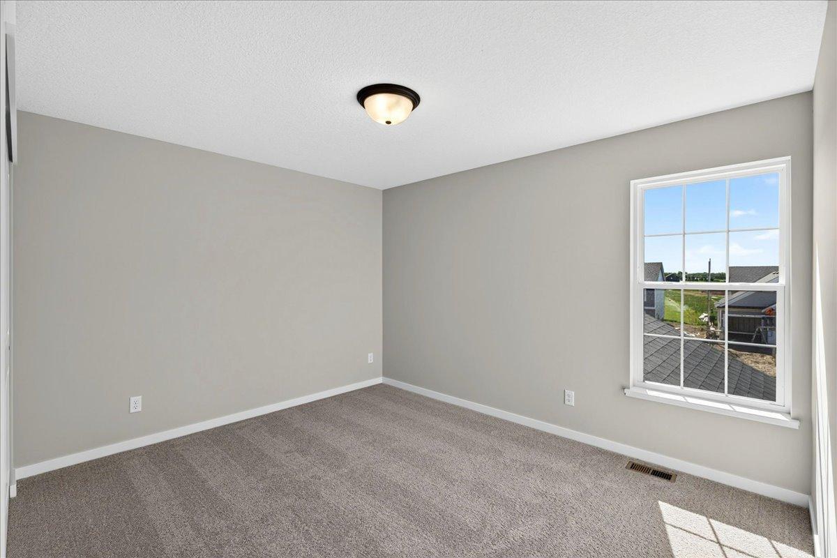 PHOTO OF A DIFFERENT HOME WITH SIMILAR PLAN & FINISHES. Bedroom 2.