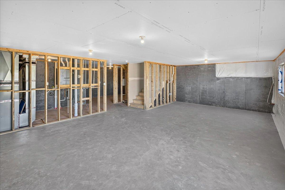 PHOTO OF A DIFFERENT HOME WITH SIMILAR PLAN & FINISHES. Unfinished Walkout Lower Level ready for future finish including a future family room, bedroom 5, and bathroom.