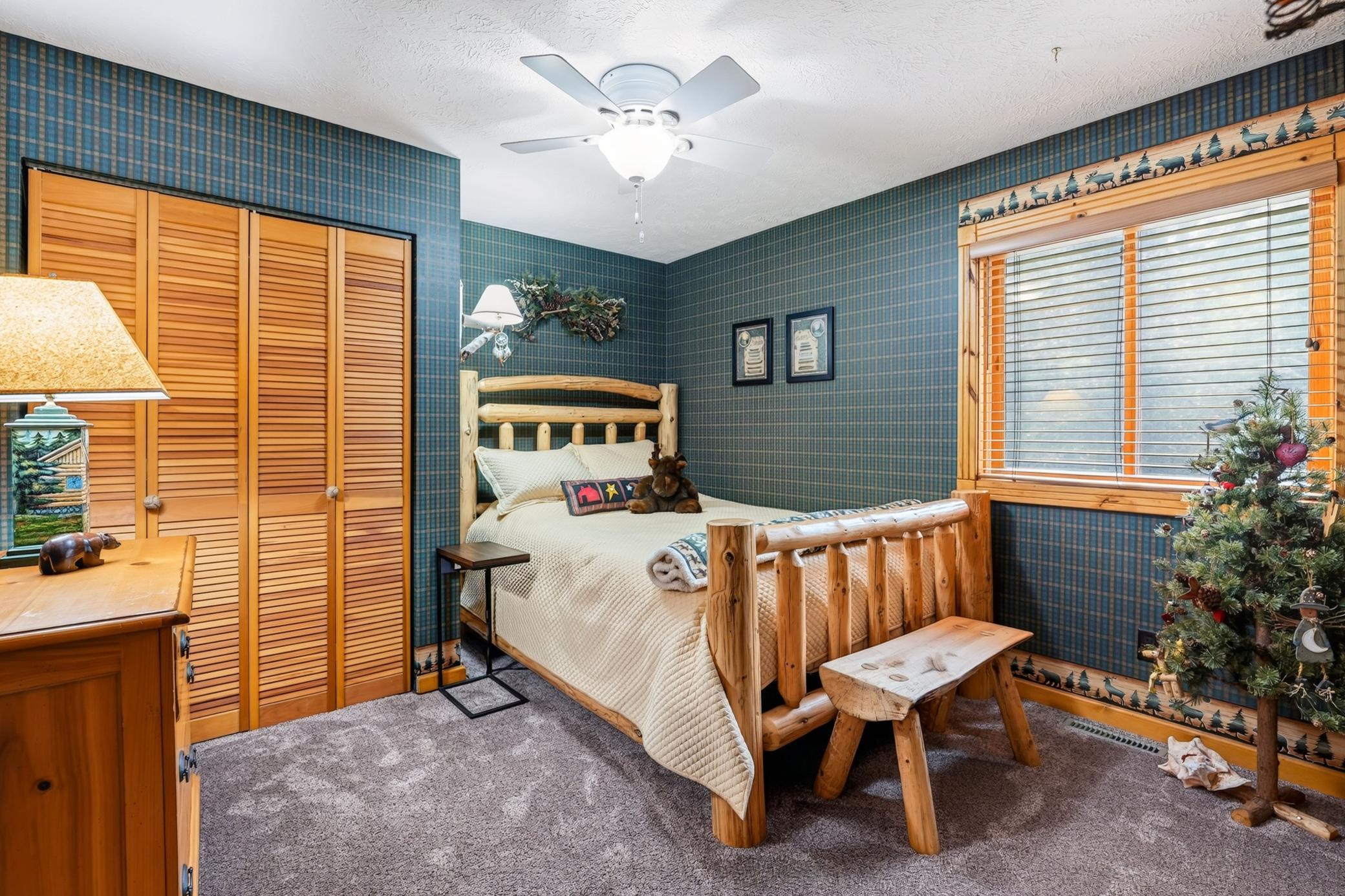 Main-level bedroom with ceiling fan.
